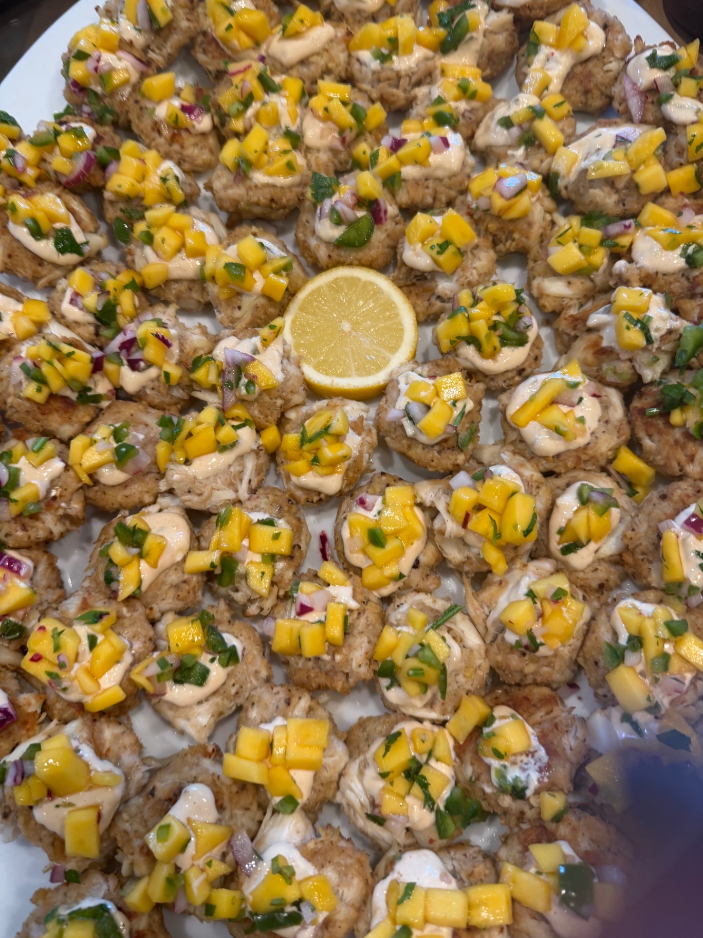 Mini crab cakes with mango salsa and aioli